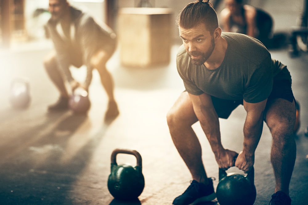 man lifting kettlebell how to get a great workout